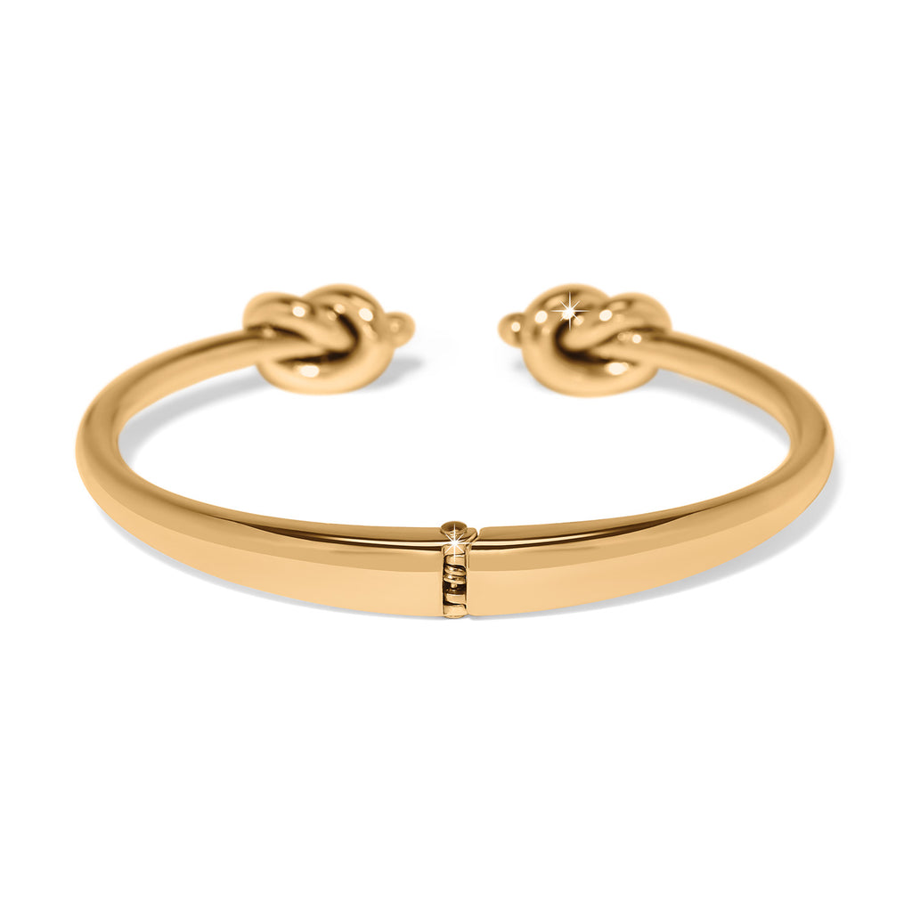 Gold bracelet with knot designs on a white background