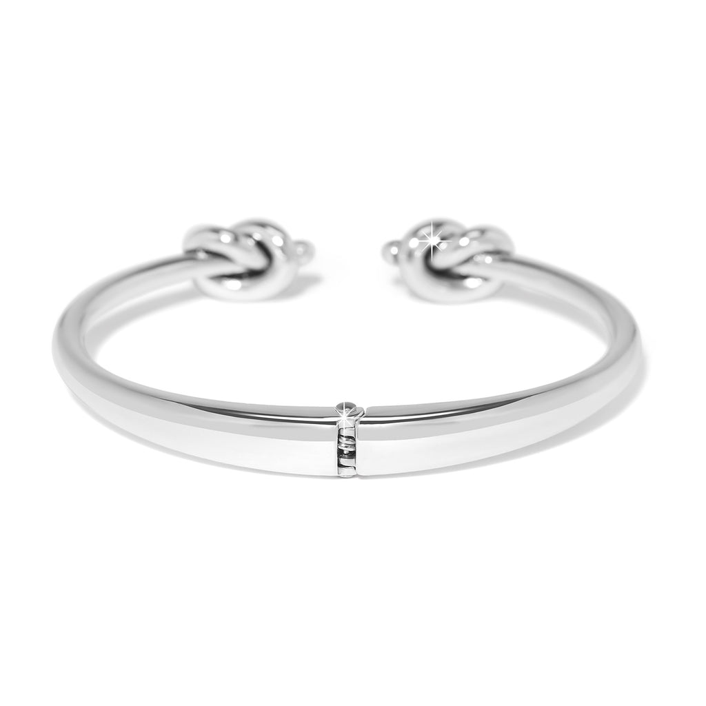 Silver bracelet with knot designs on a white background